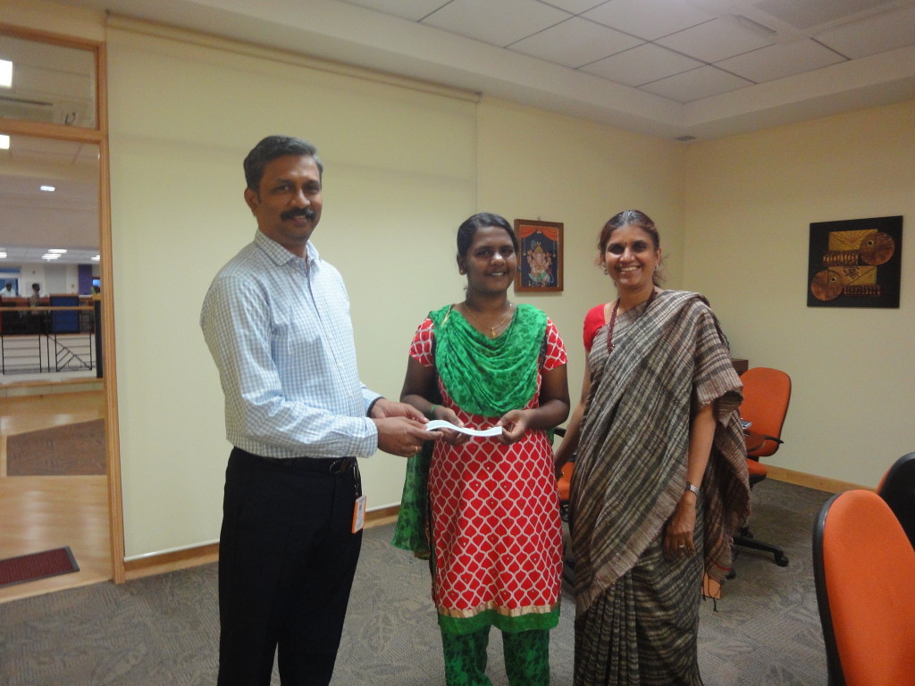 The trustees of Sriram Charitable Trust handed over the education scholarship to Padmasri, a BTech (EEE) first-year student, to pay for her annual college fees